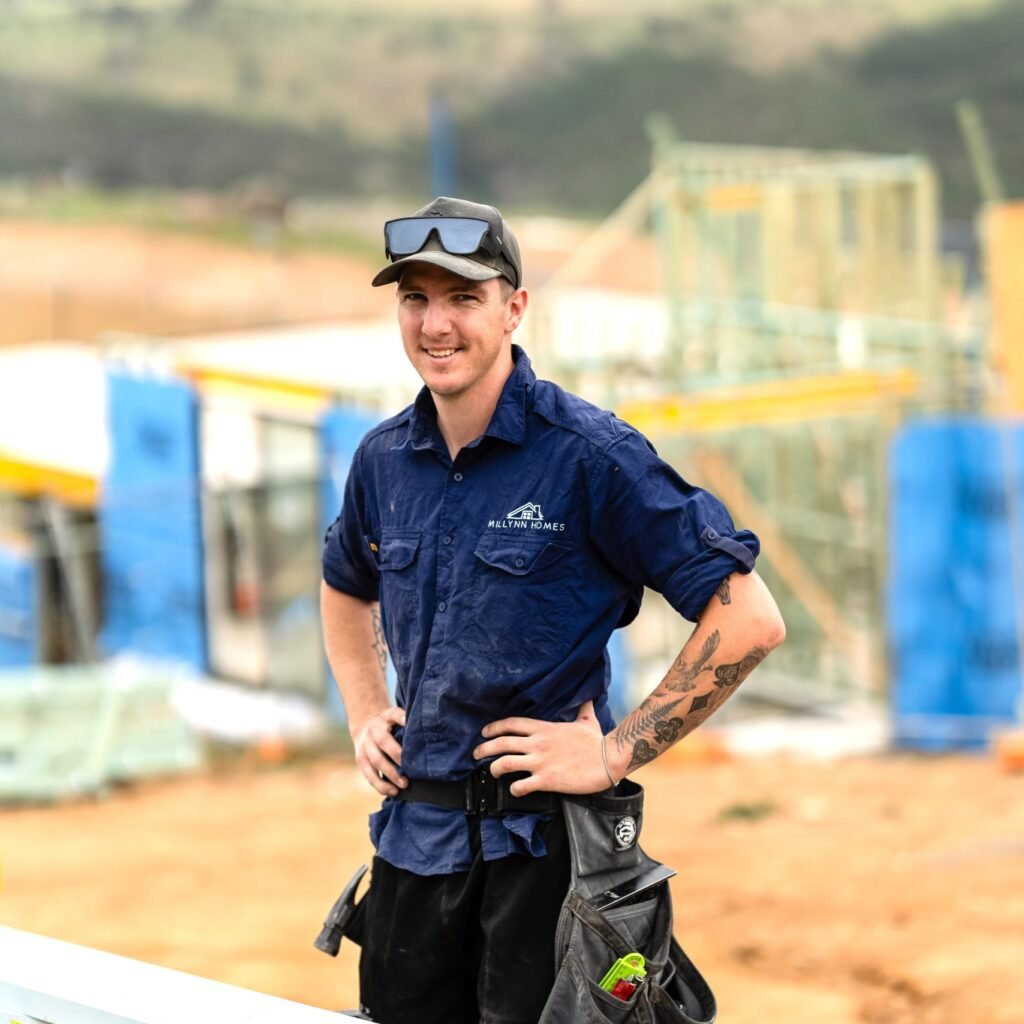 Professional carpenter standing at residential build site