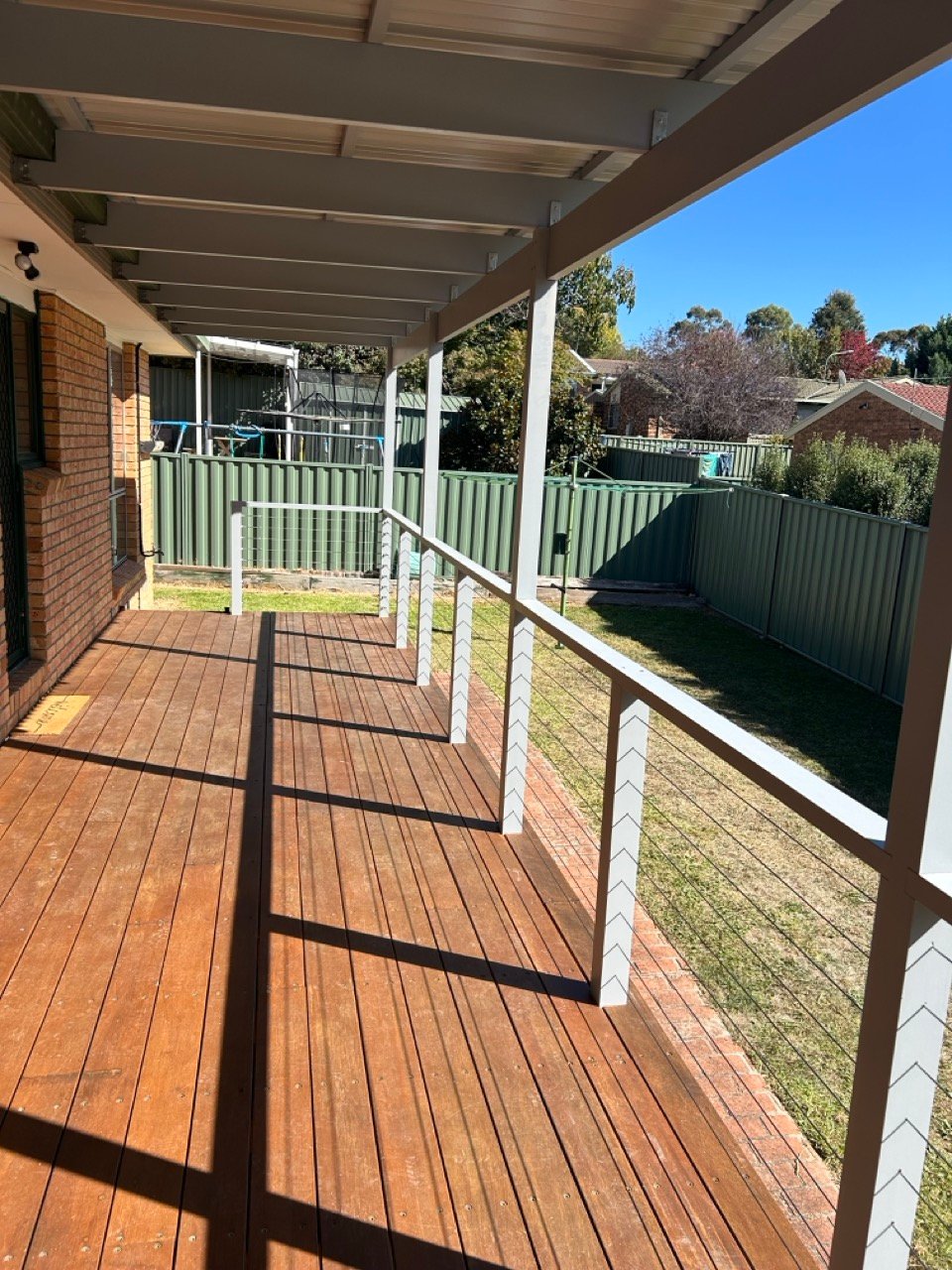 Pergola deck with timber flooring and railing