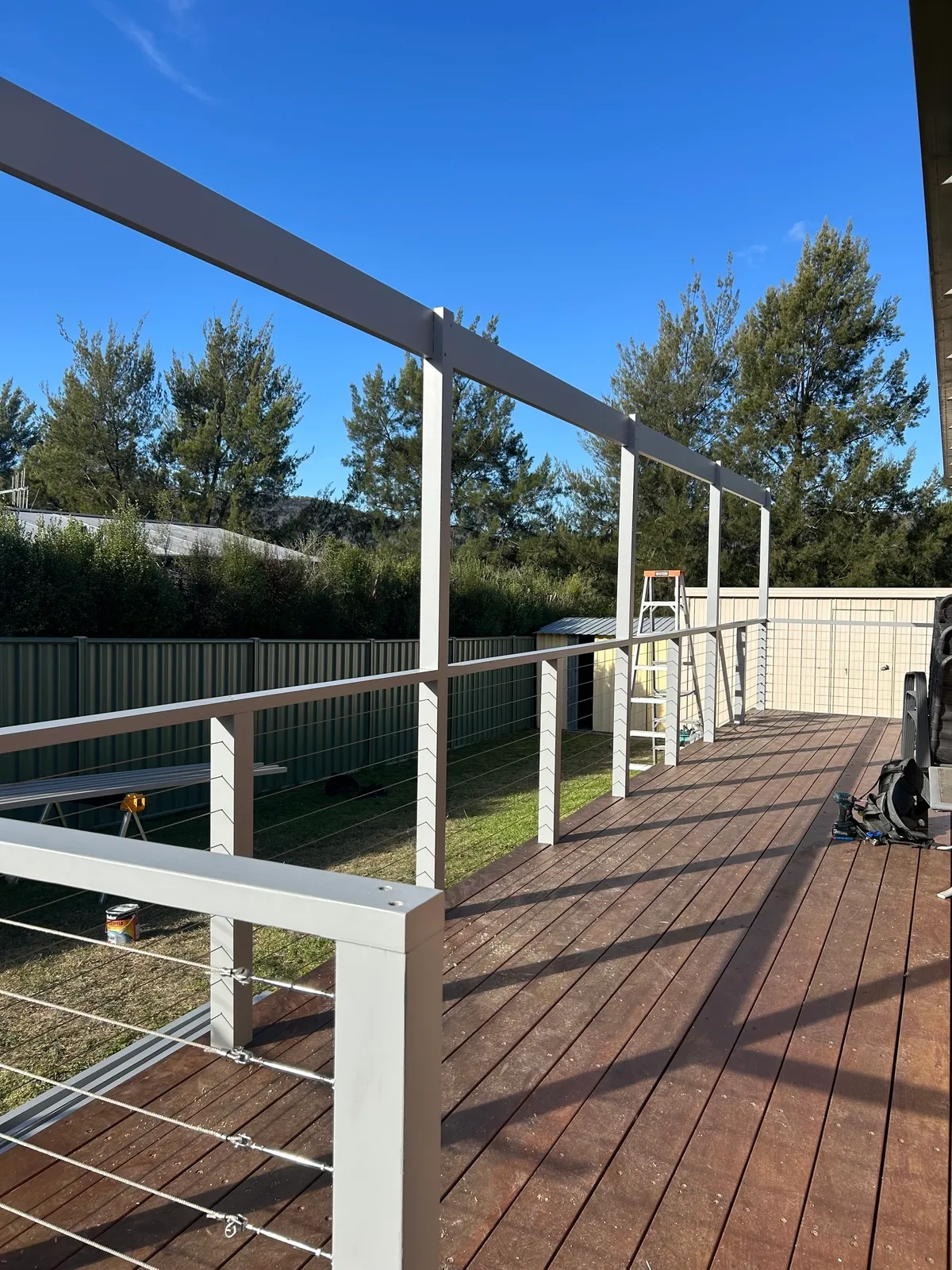 Timber deck walkway with railing and pergola posts