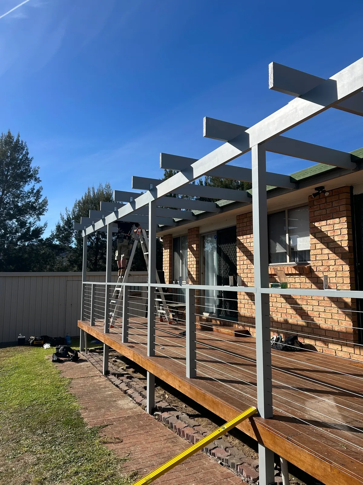 Custom pergola installation in backyard